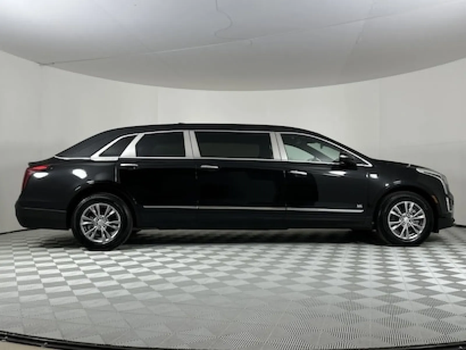 Sleek black limousine showcased in a studio setting, highlighting luxury and elegance.