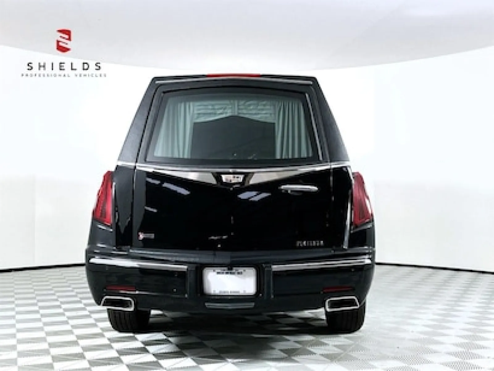 Rear view of a black luxury hearse showcasing elegant design and features.