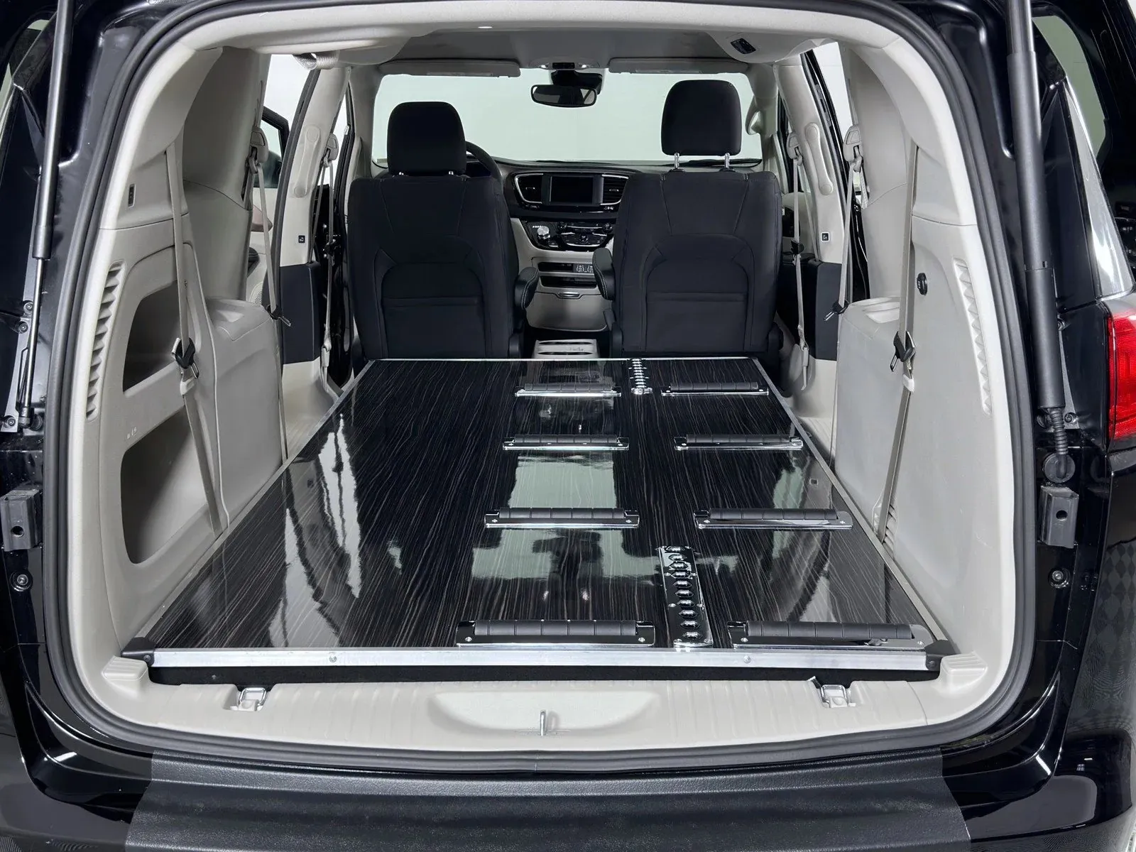 Interior of a spacious van with a flat cargo area and folding seats, ideal for transporting goods.