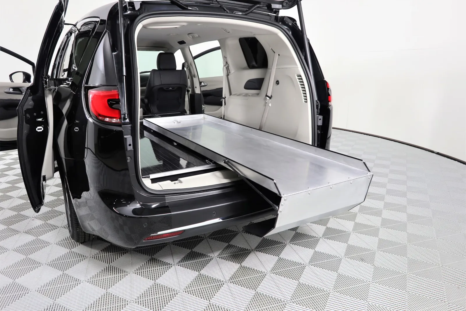 Interior view of a spacious minivan with adjustable cargo area and flat loading ramp.