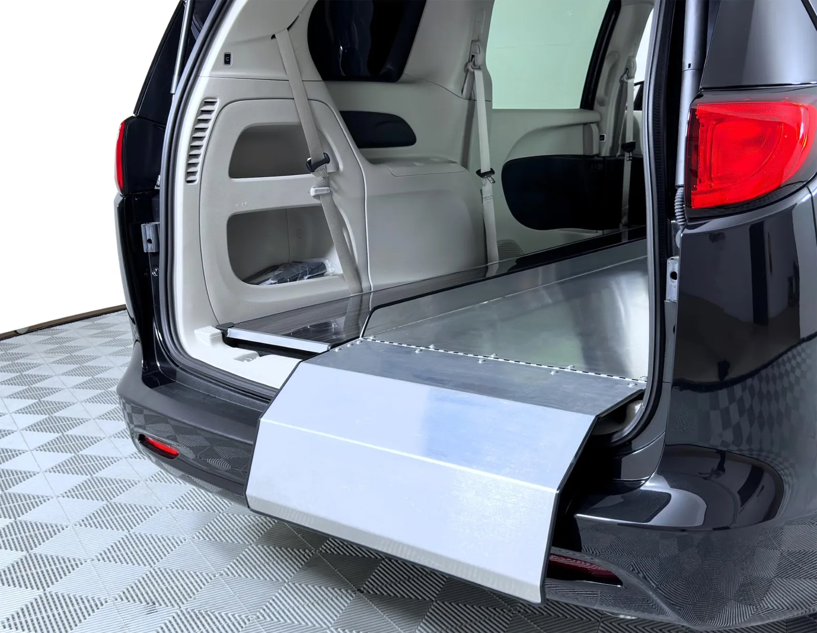 Interior view of a minivan with a lowered ramp for accessibility features.