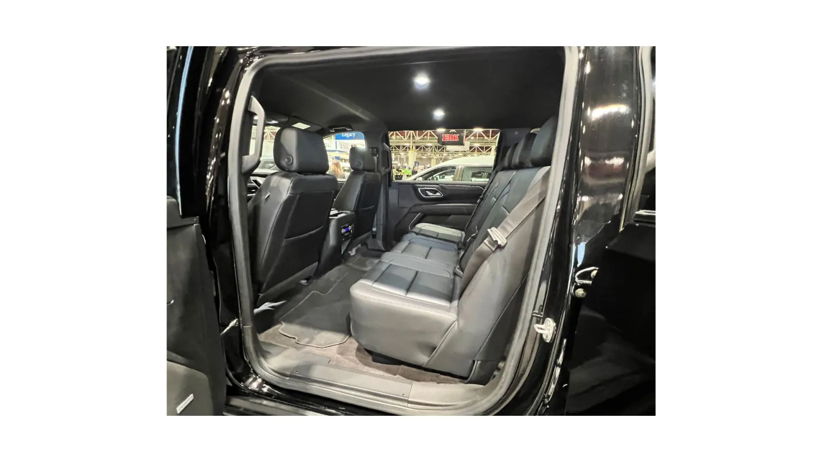 Interior view of a spacious black SUV showcasing leather seats and modern design details.