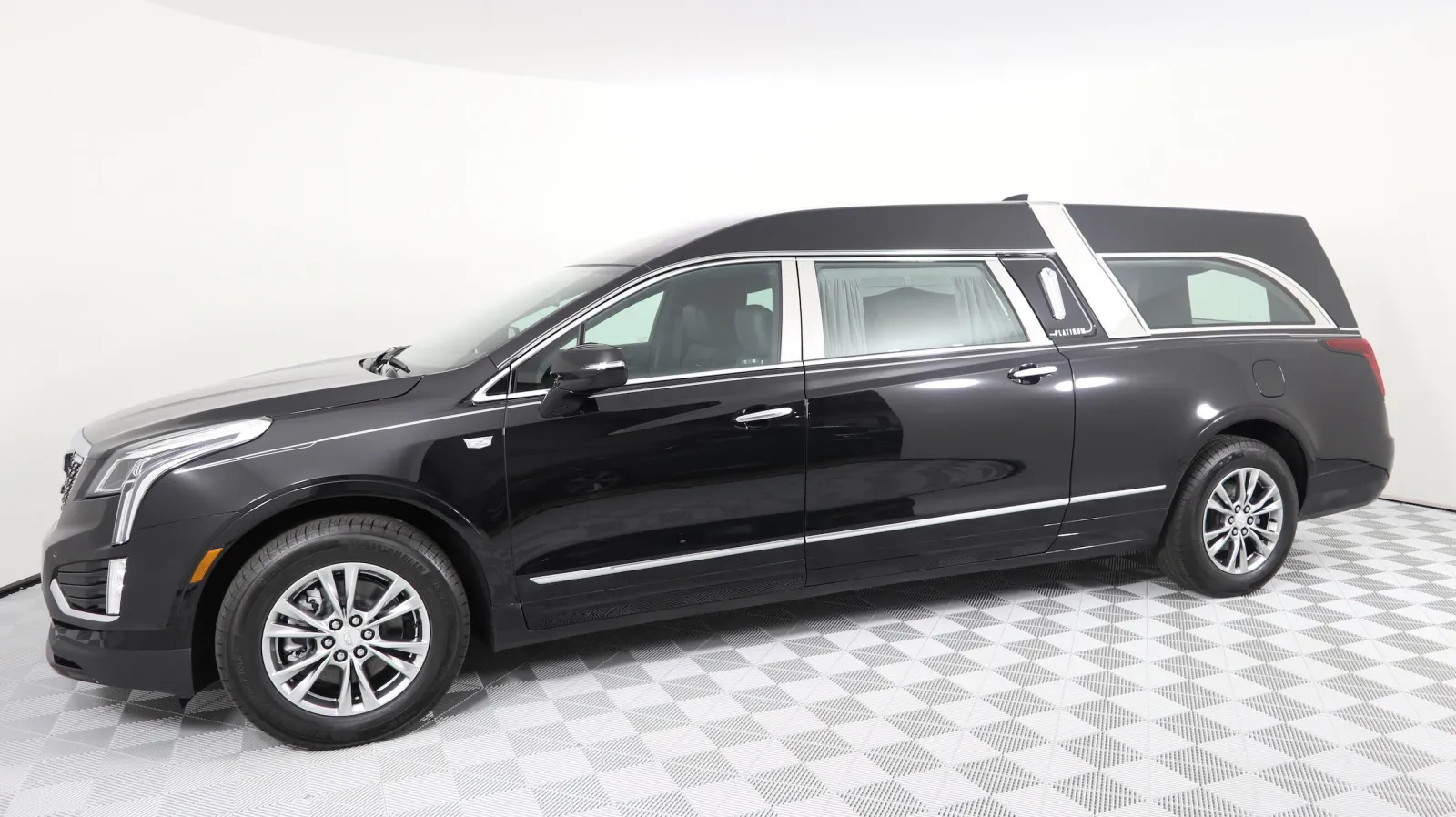 A sleek black hearse with elegant design, showcasing modern luxury and funeral transport features.