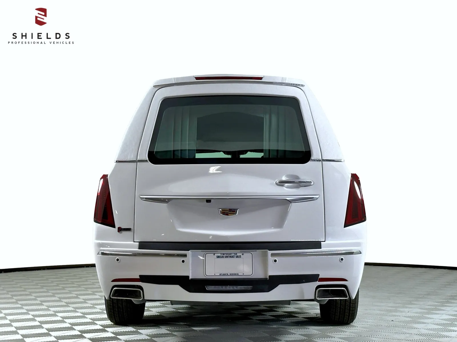 Back view of a Cadillac luxury vehicle featuring a sleek white exterior and modern design.