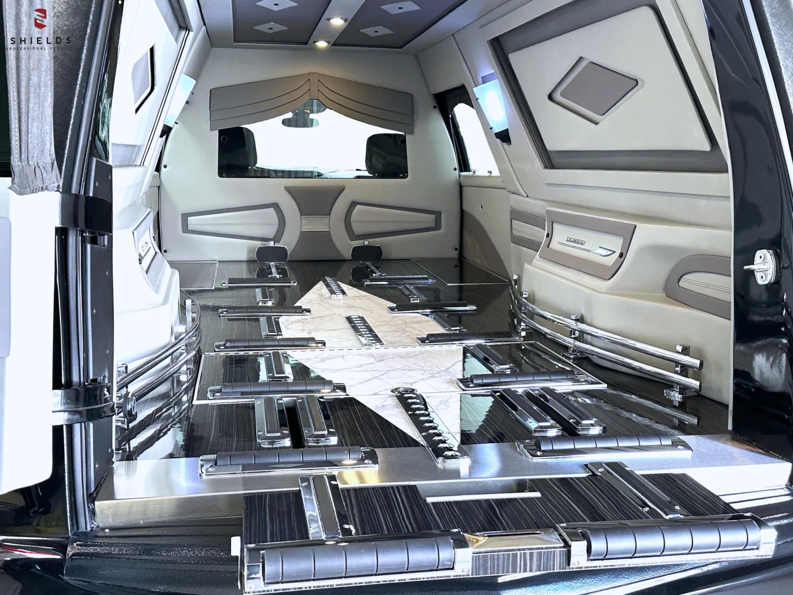 Interior of a luxury car featuring sleek black and silver design with a spacious layout.