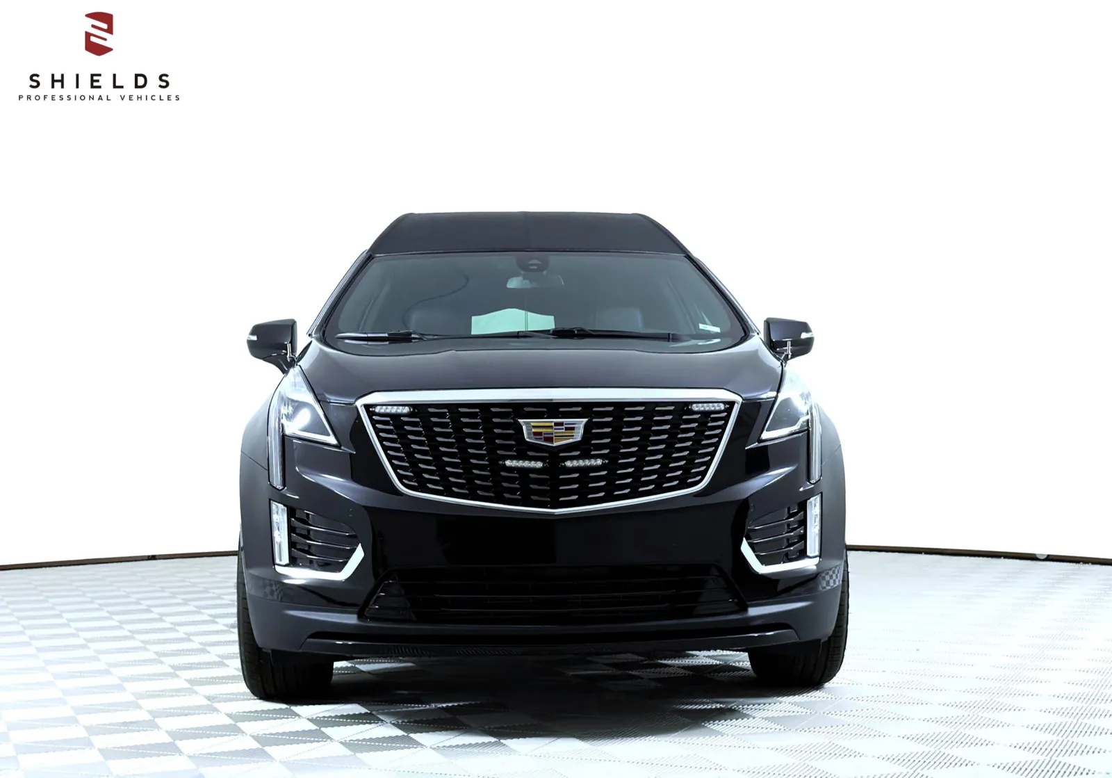 Front view of a black Cadillac XT5 showcasing modern luxury design and prominent grille.
