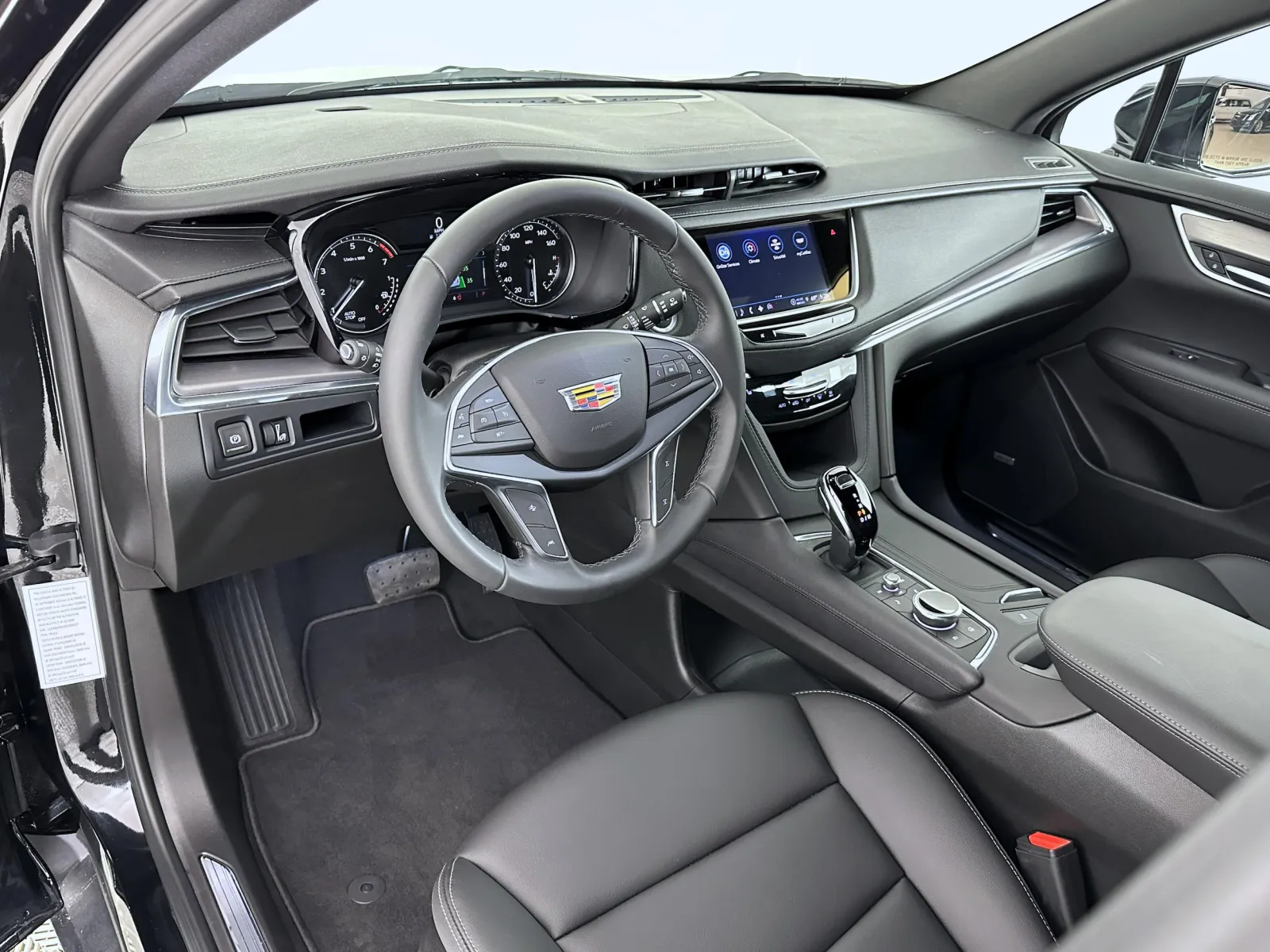 Luxurious interior of a modern Cadillac showcasing leather seats and advanced technology dashboard.