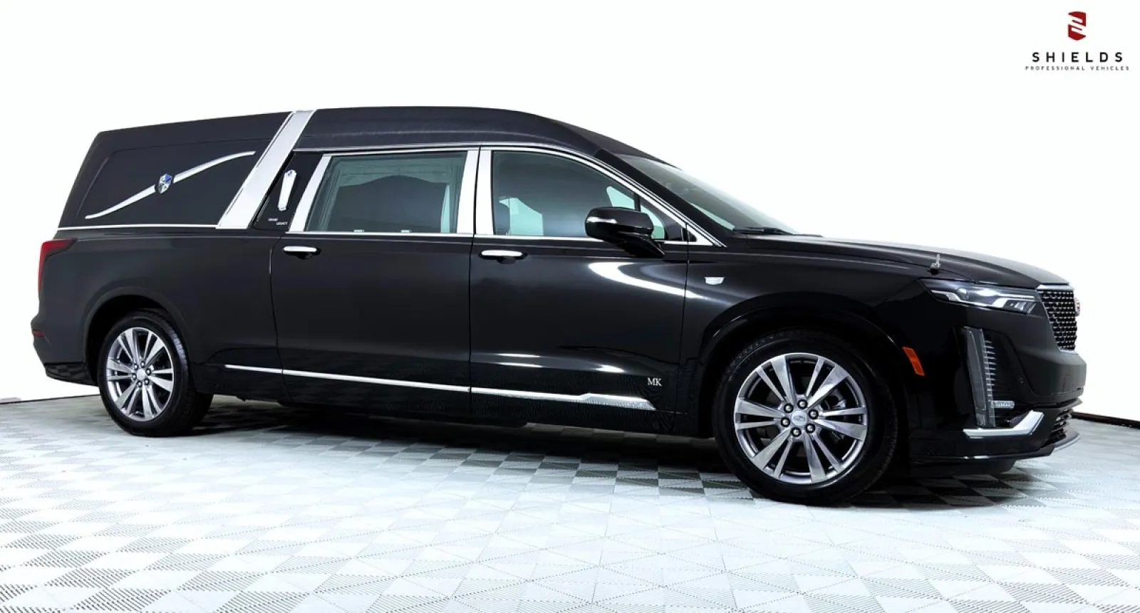 A sleek black luxury hearse with elegant design features and smooth lines.