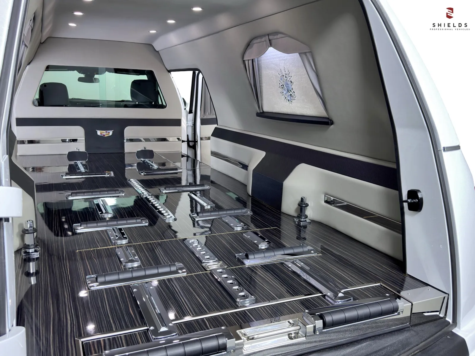 Interior of a luxury hearse showcasing sleek design and refined materials with ample space.