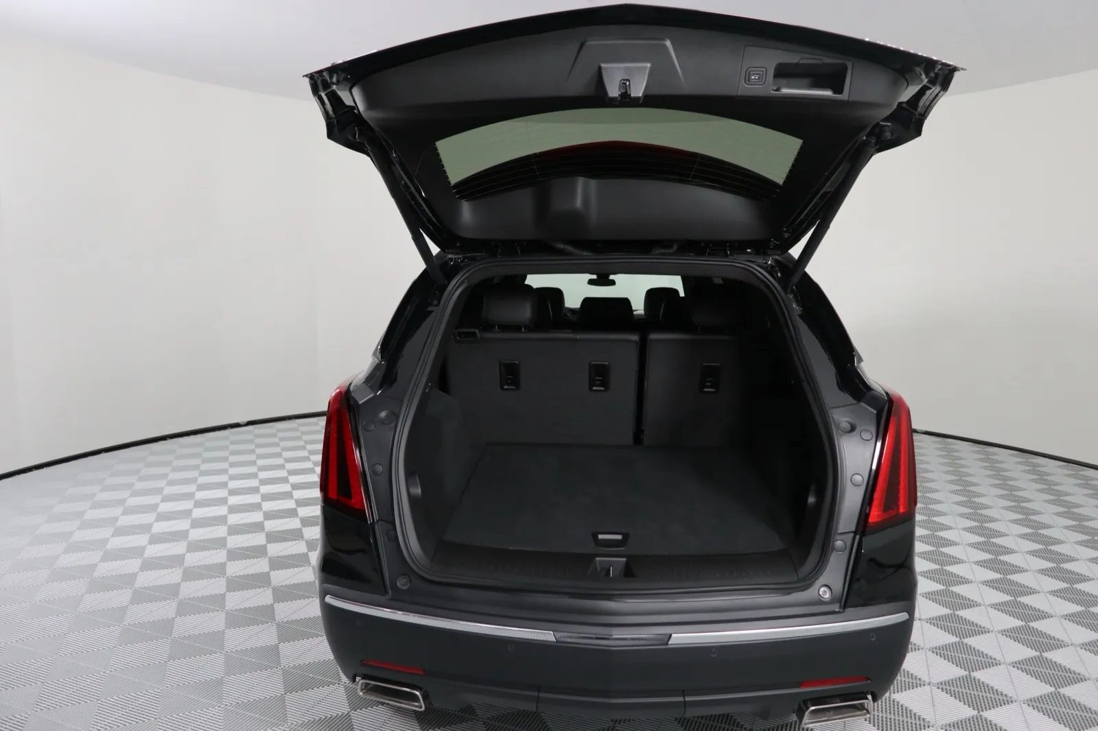 Interior view of an SUV with the trunk open, showcasing ample cargo space and a sleek design.