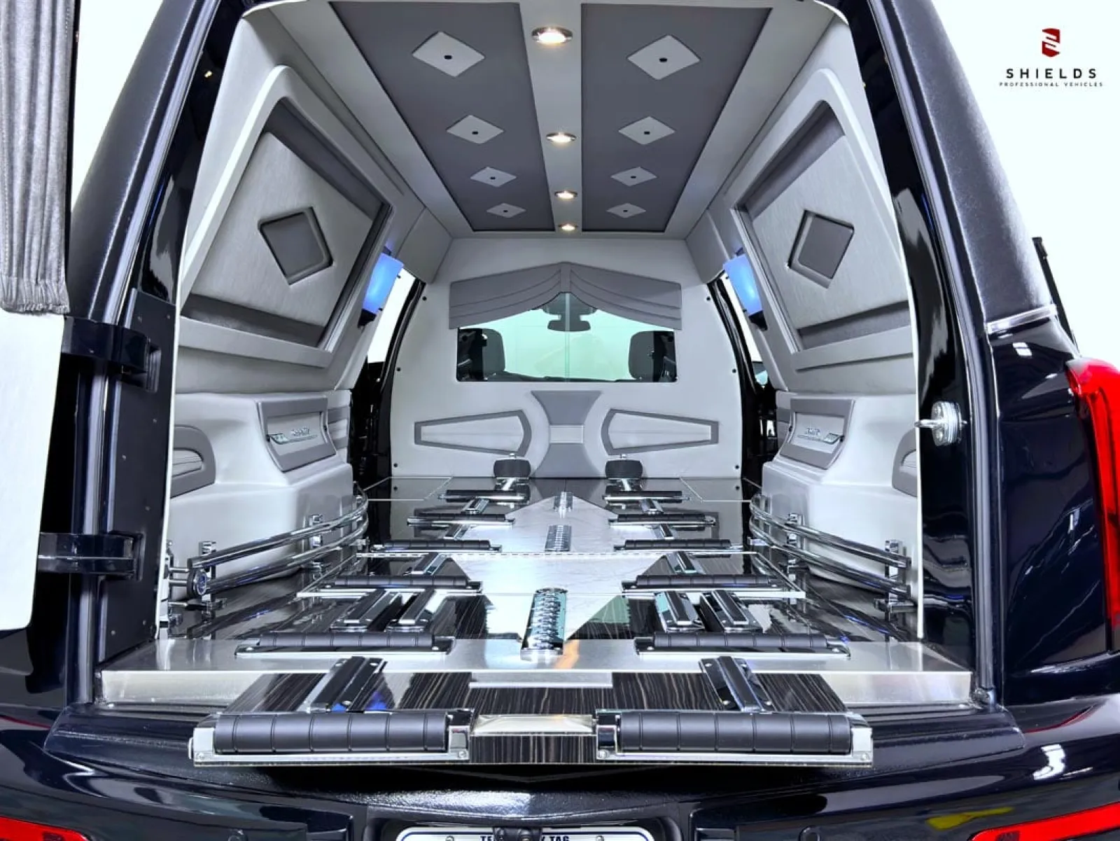 Luxurious interior of a black van showing spacious seating and modern design elements.