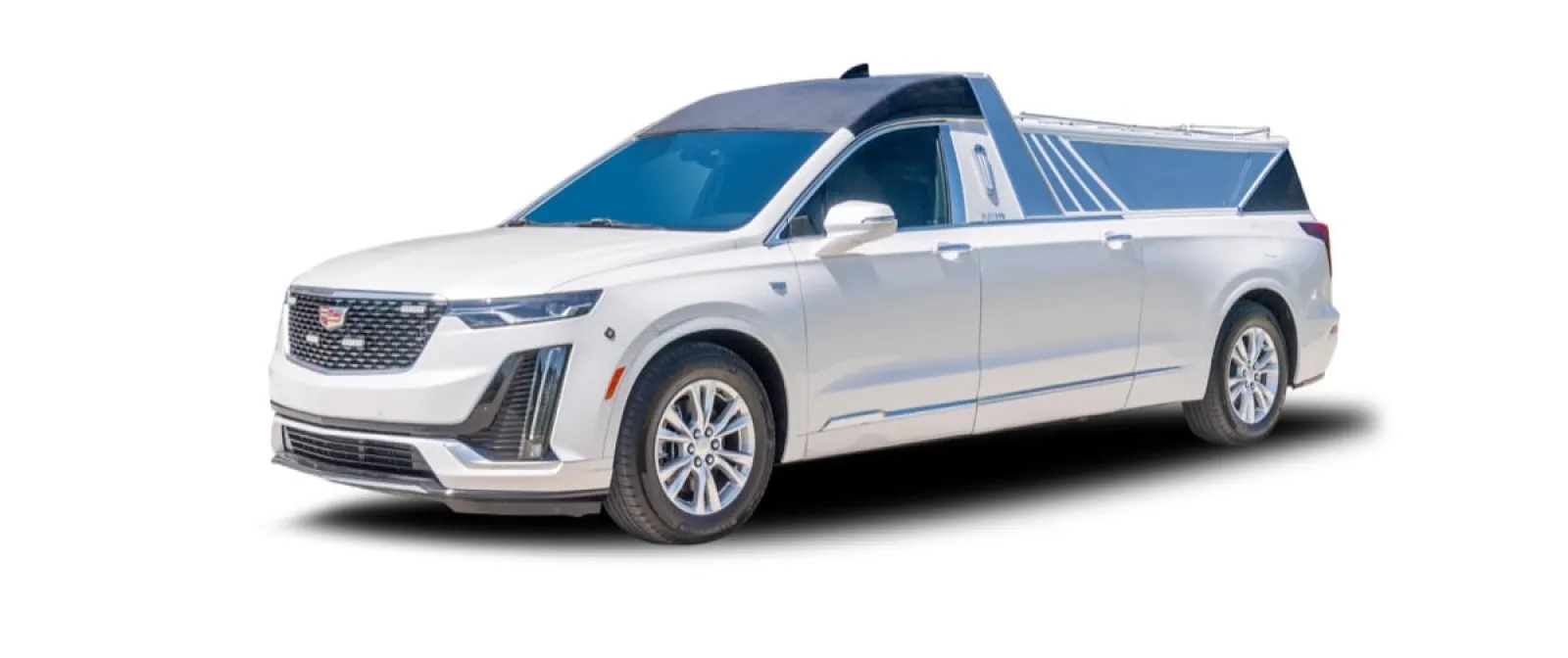 White Cadillac XT6 SUV with a custom truck bed design, showcasing sleek lines and modern features.