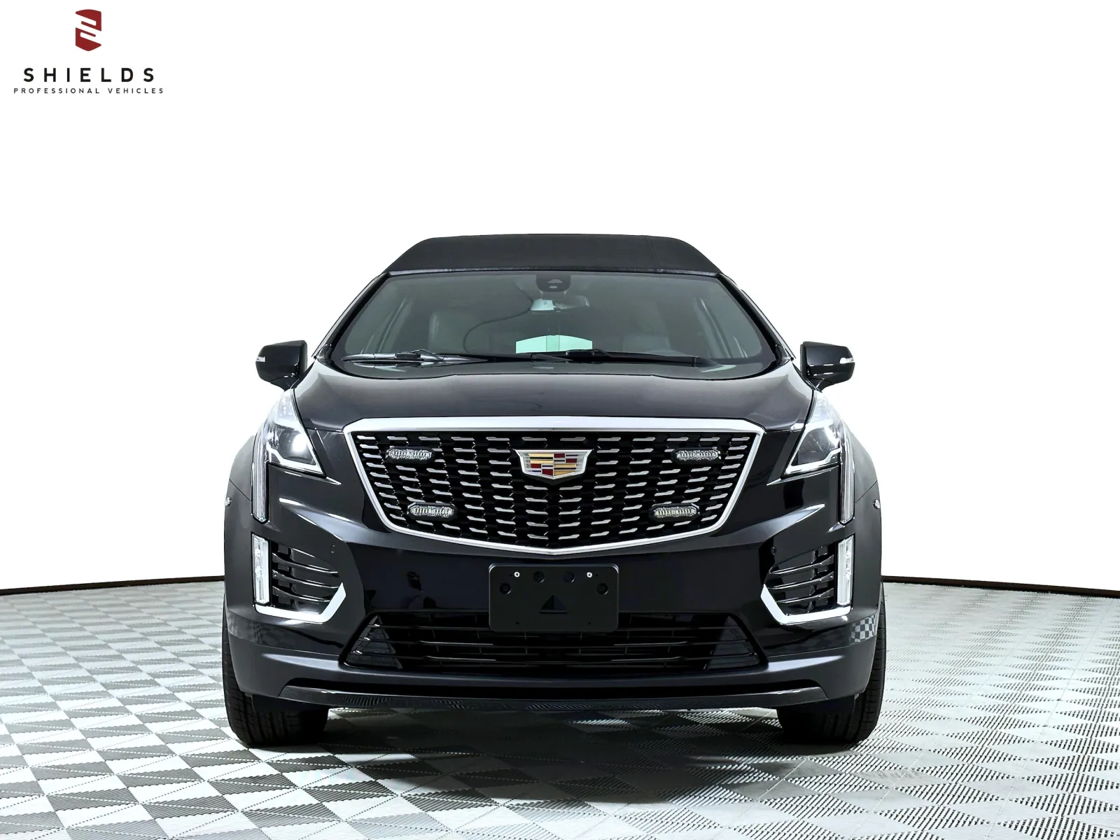 Front view of a sleek black Cadillac vehicle showcasing modern design features.
