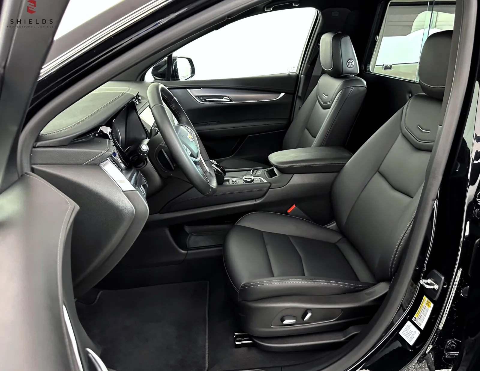 Interior view of a modern black SUV showcasing leather seats and refined design features.