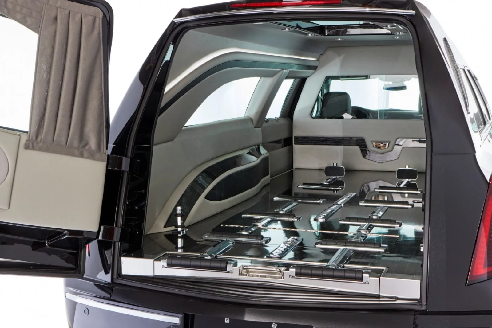 Interior view of a luxury hearse, showcasing sleek design and polished surfaces.