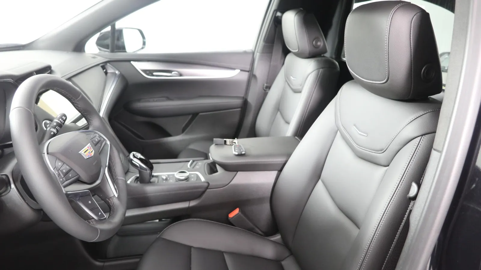 Interior view of a luxurious Cadillac car featuring sleek black leather seats.