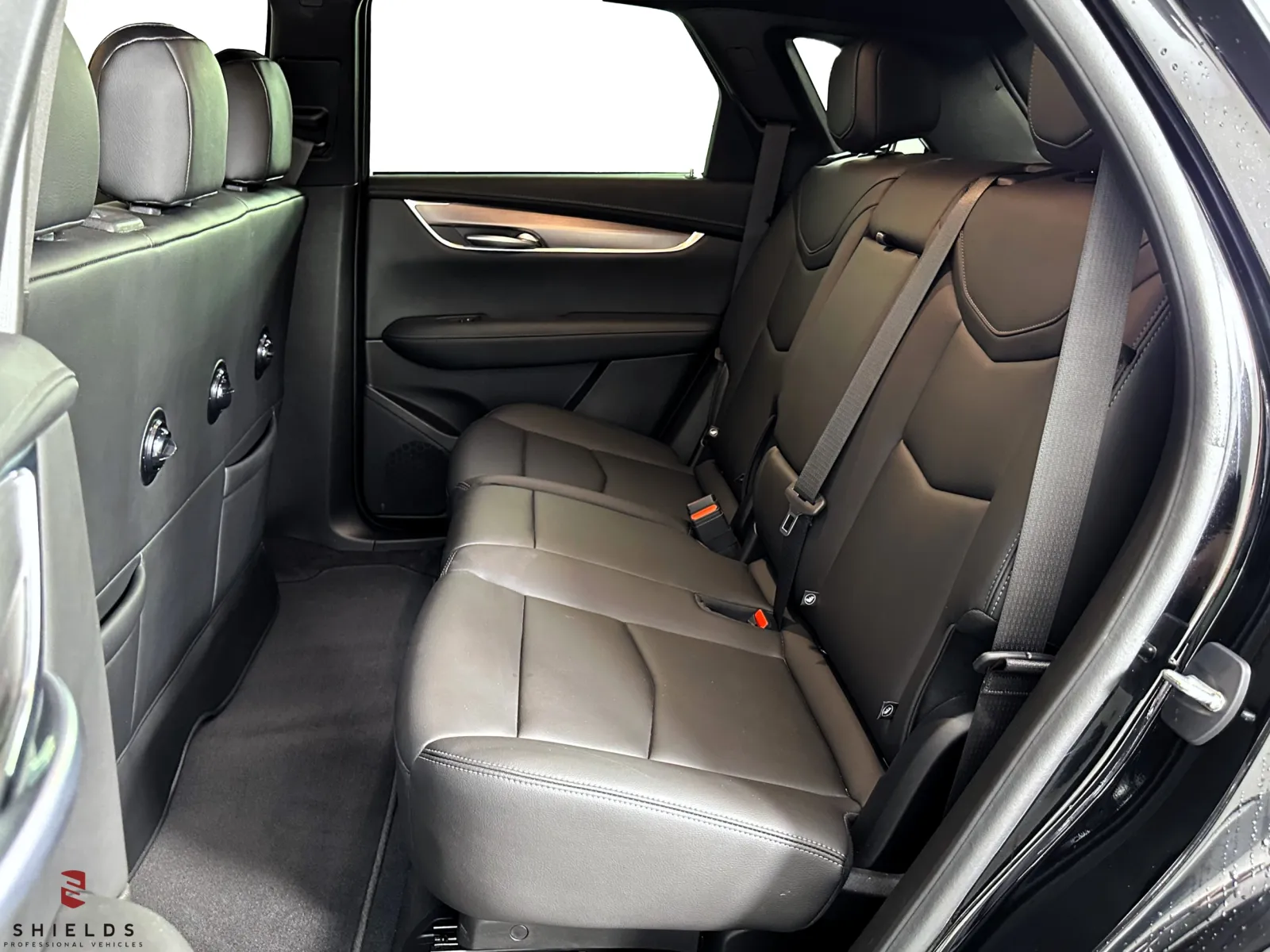 Interior view of a modern vehicle’s spacious rear seating area with leather upholstery.