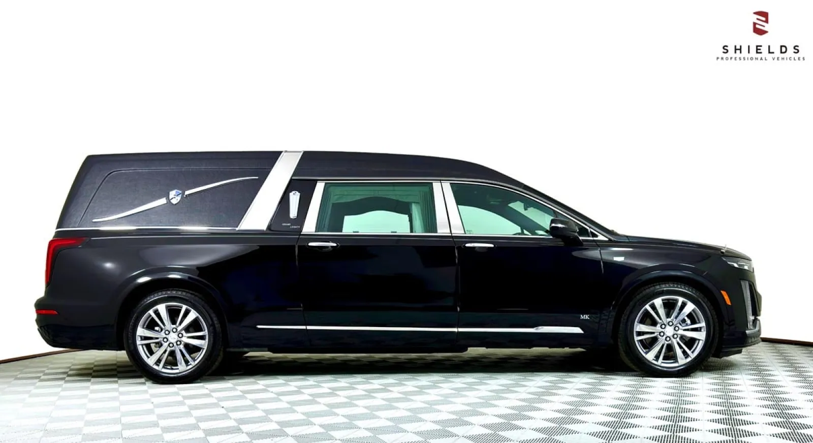 Black hearse with a sleek design, showcasing professional funeral vehicle features.