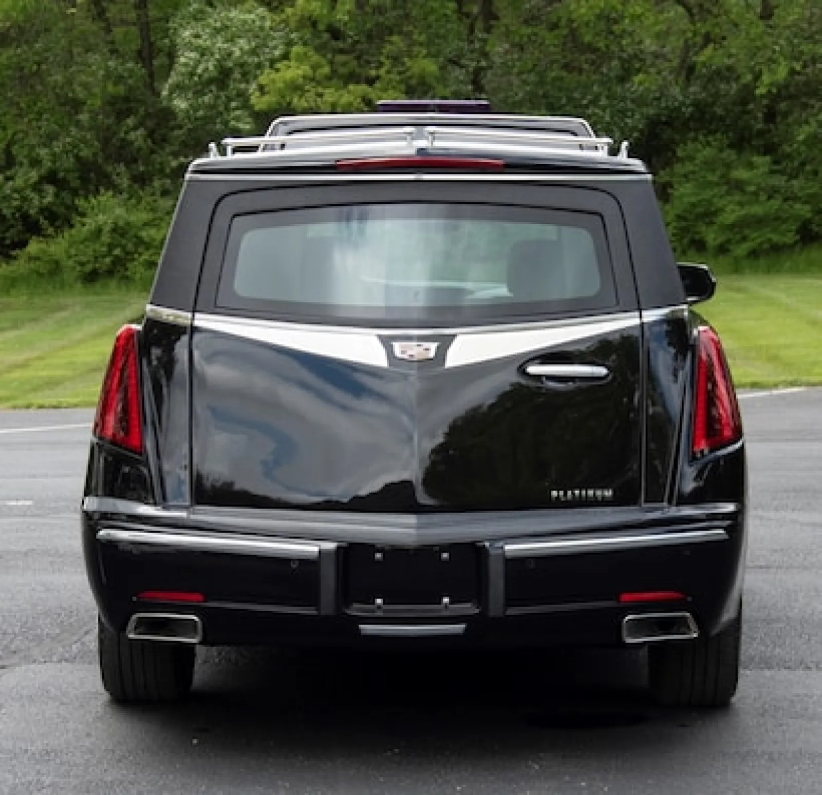 Rear view of a black Cadillac Platinum with sleek lines and luxury design features.