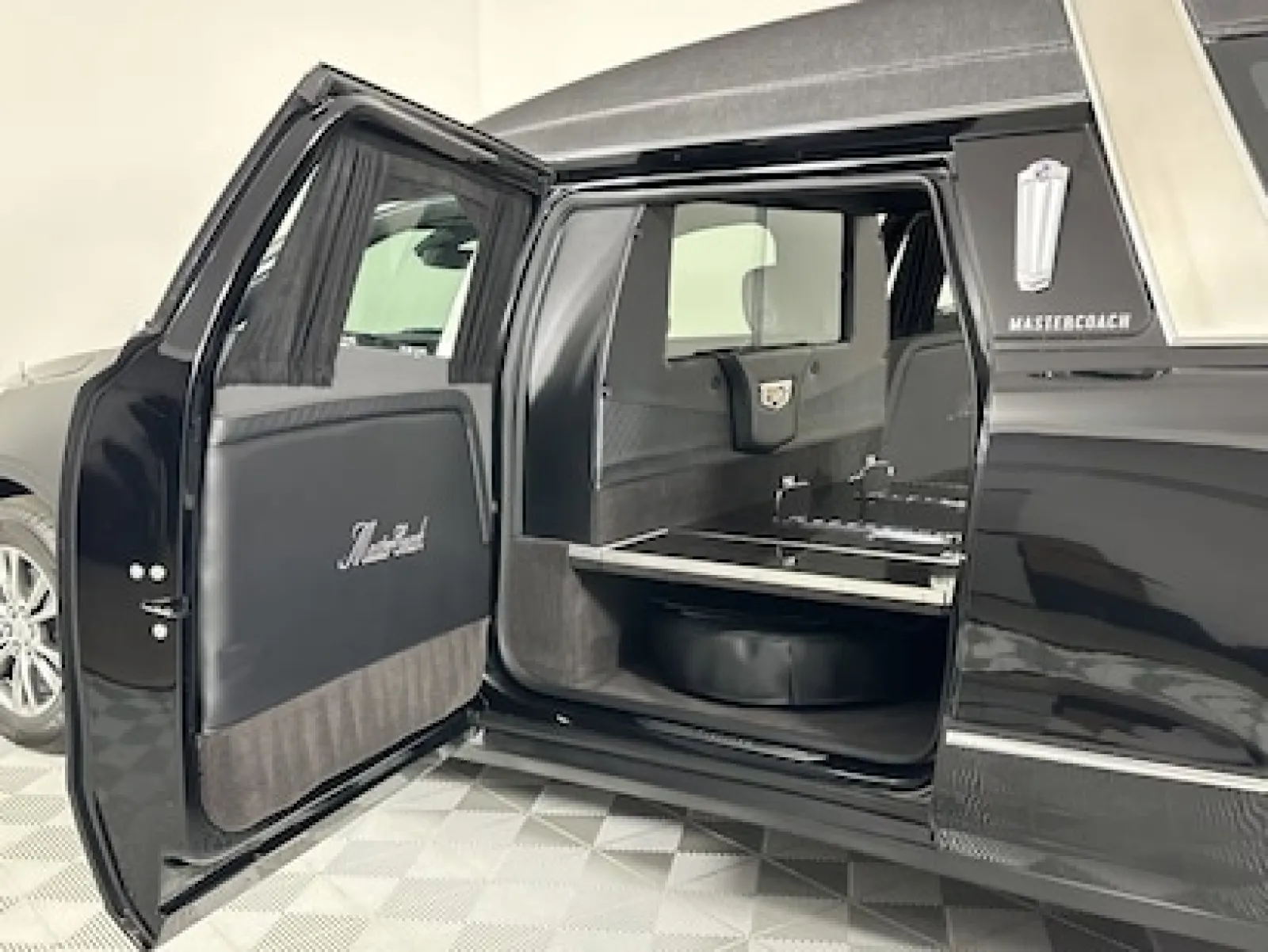 Interior view of a luxury hearse featuring spacious seating and a sleek design.