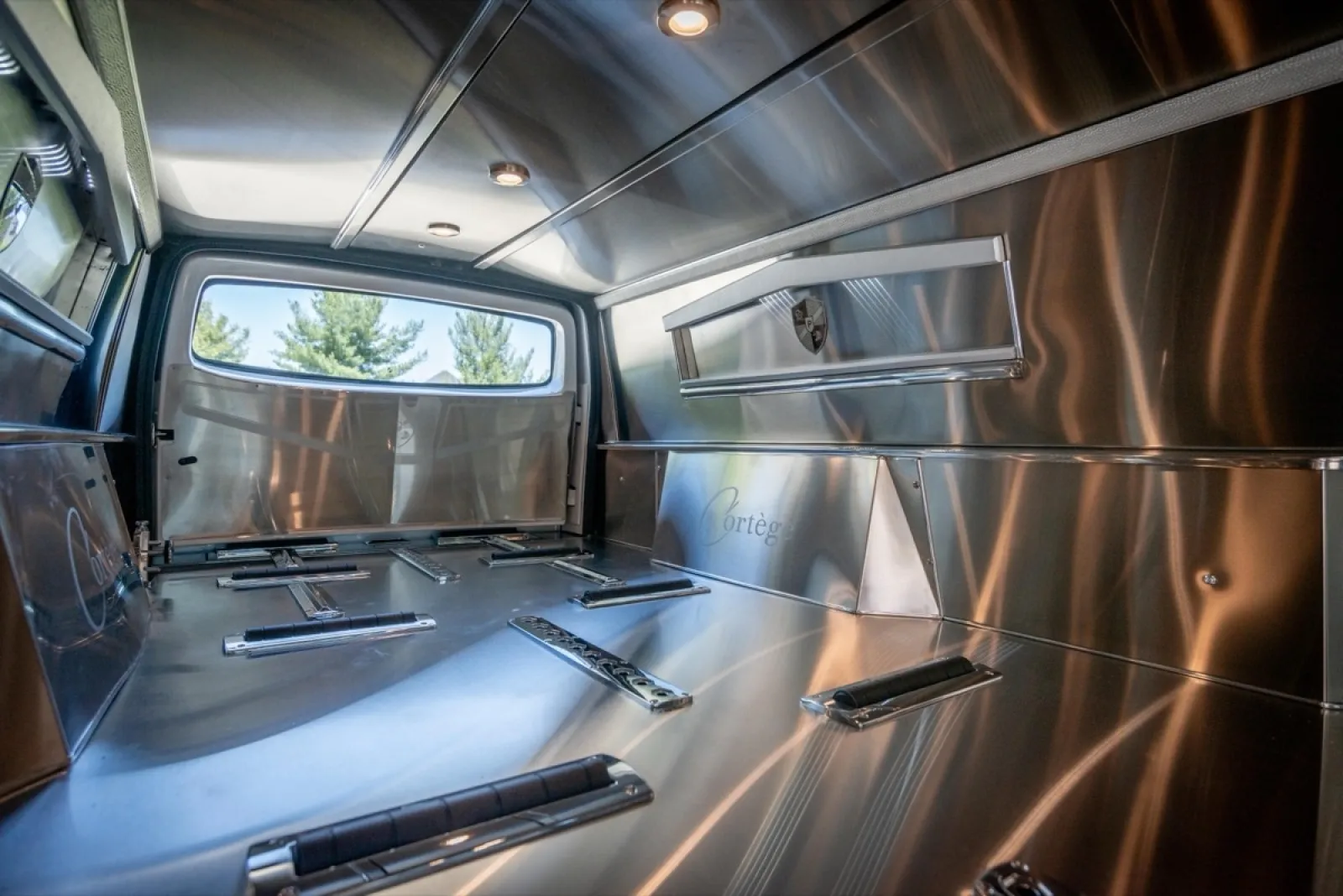 Interior of a stainless steel truck bed showcasing sleek design and functional layout.