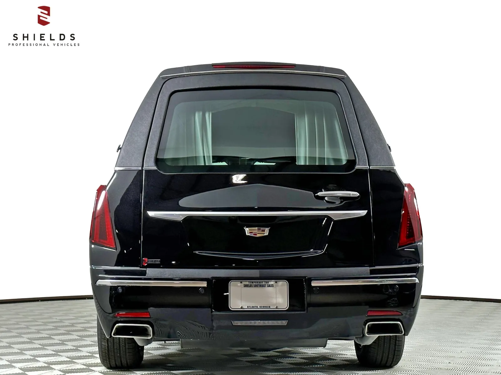 Rear view of a black Cadillac with sleek design and premium features.