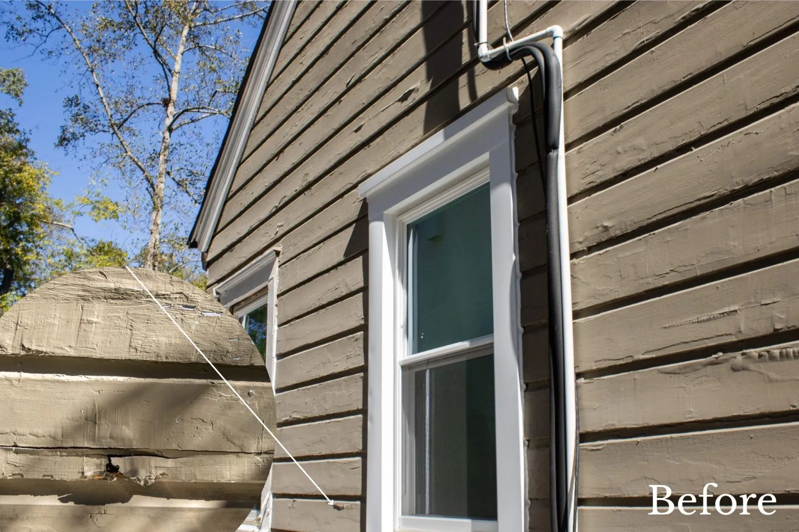 Weathered brown wooden siding home exterior with visible cracks, uneven surfaces, and aging trim before renovation in Atlanta