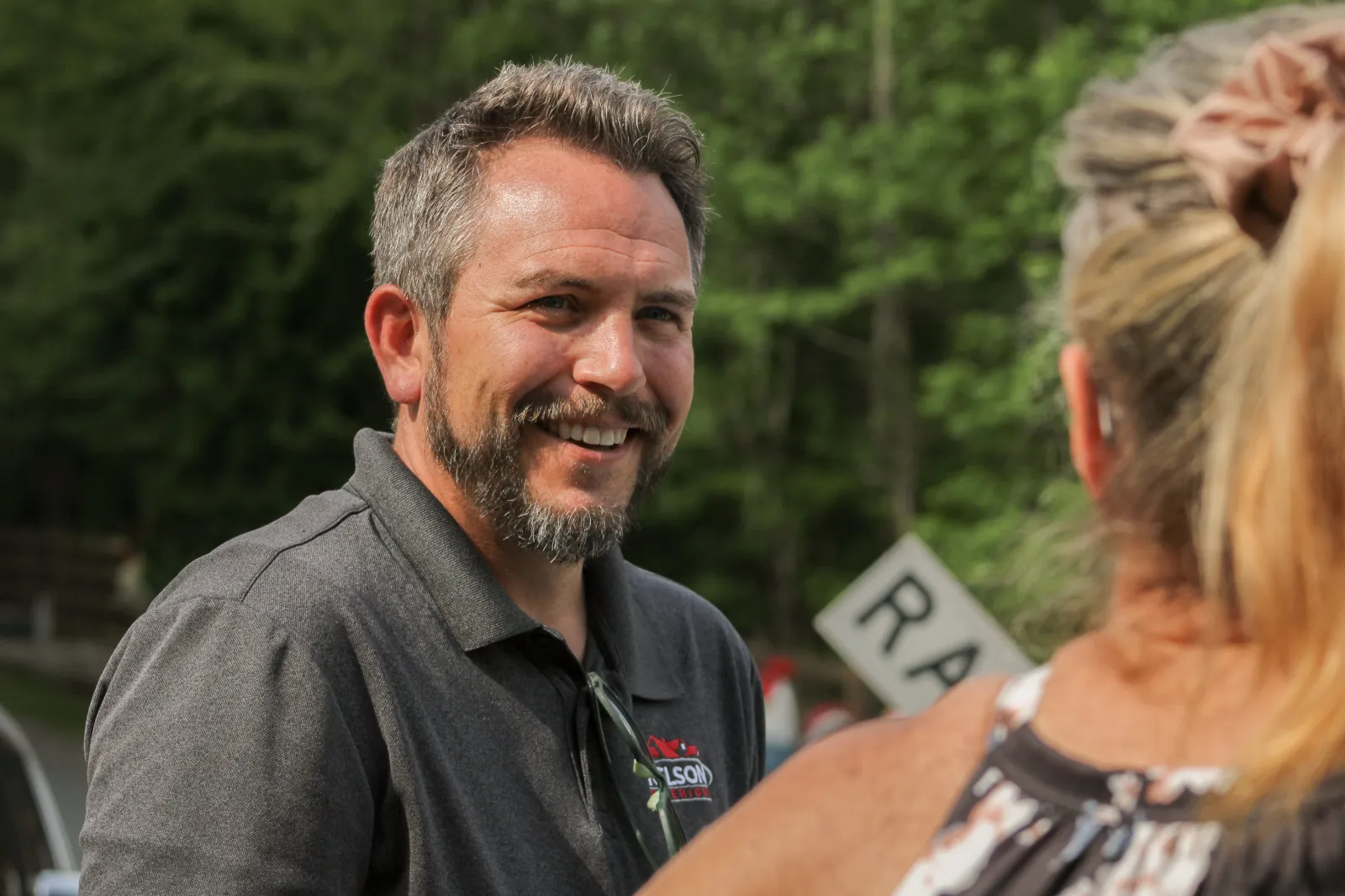 Nelson Exteriors team member discussing fiber cement siding pros and cons with homeowner in Marietta GA