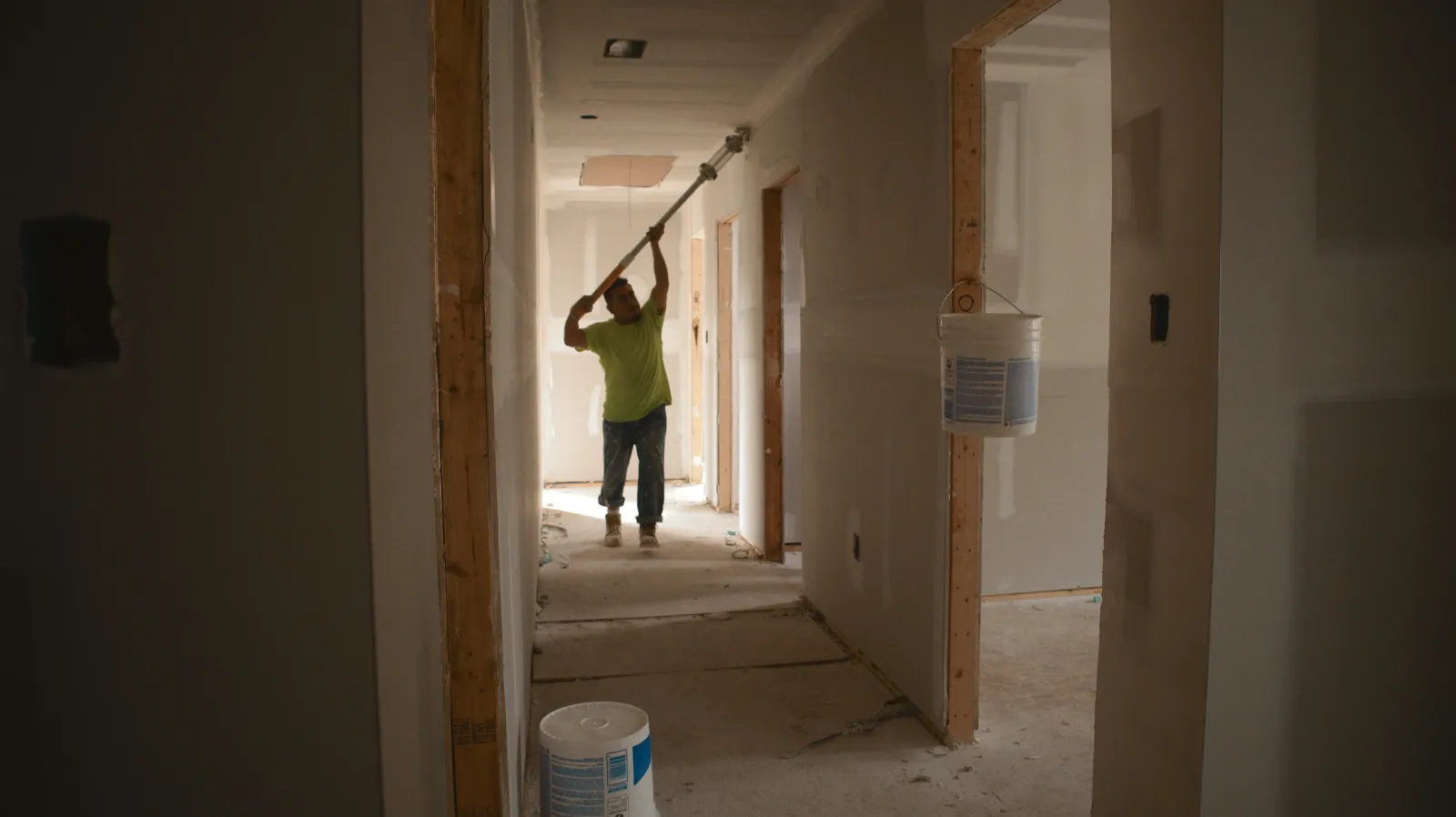 Nelson Exteriors crew painting ceiling in hallway of home under renovation in Marietta