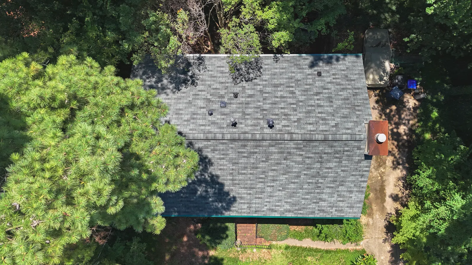 Direct overhead drone view of a newly shingled gray asphalt roof deck, visually explaining what is a roofing square by measuring total surface area coverage for roof replacement in Marietta by Nelson Exteriors.