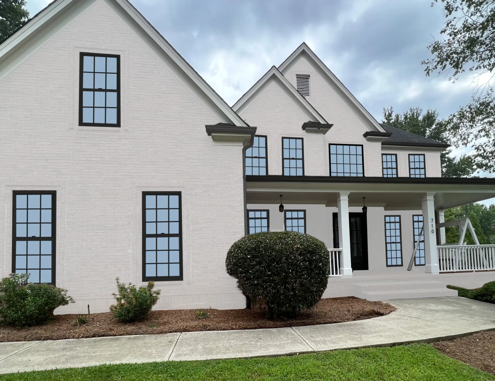 Rendering showing what a home could look like with white paint and new black windows.