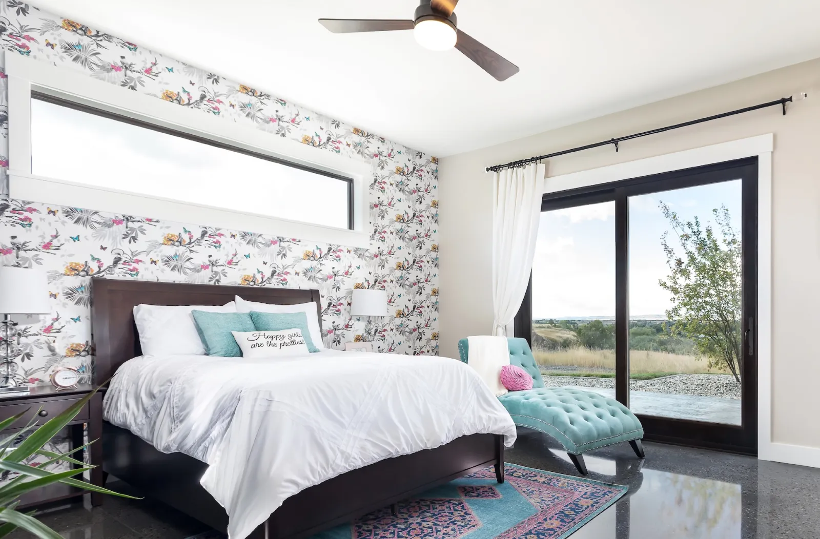 Sliding French Door with black frame in bedroom with floral wallpaper provides view to backyard and trees