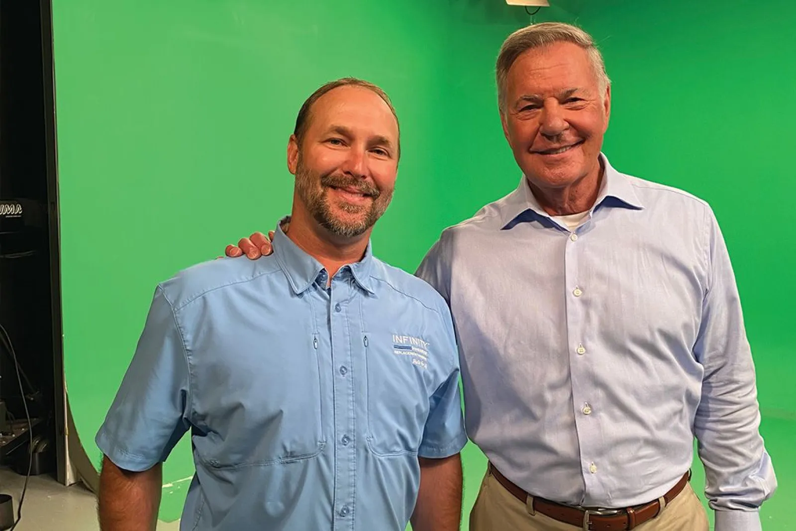 Meteorologist Glenn Burns and North Georgia Replacement Windows owner Ted Kirk pose for the camera during a video shoot