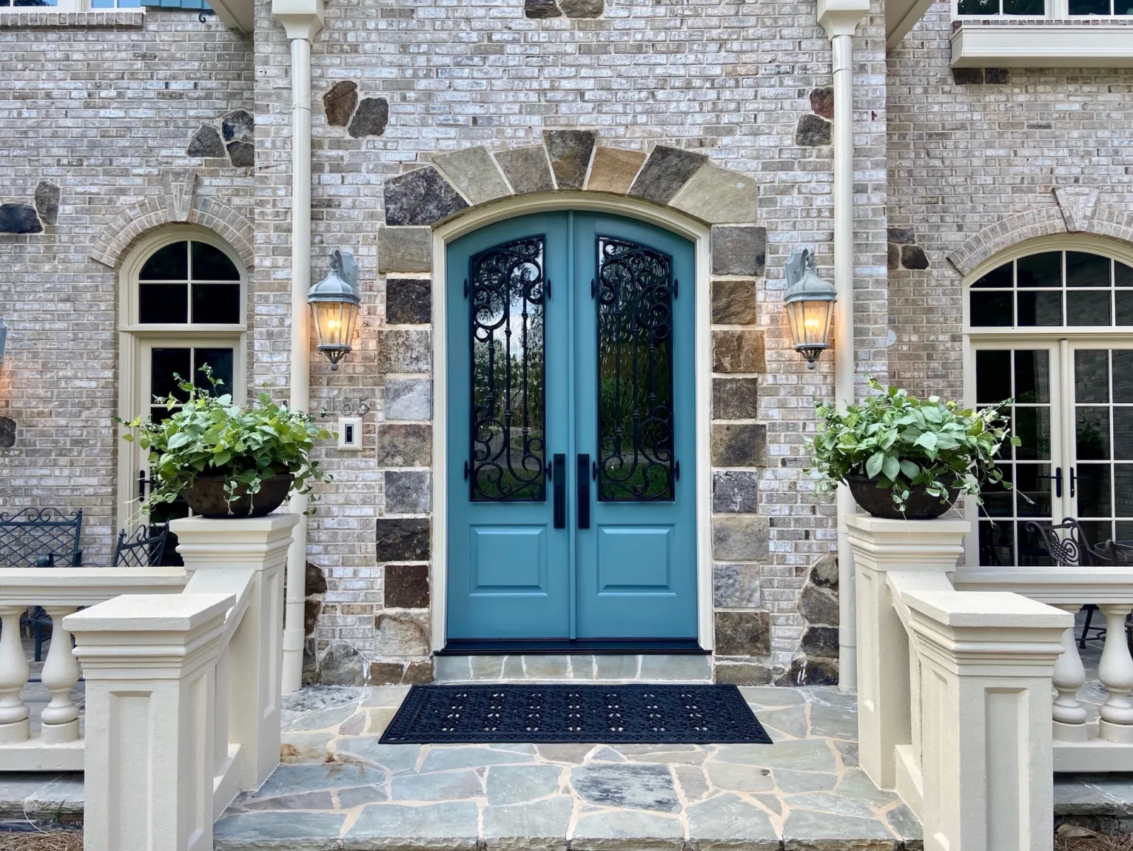 A stone house with blue double entry doors from MaxCraft