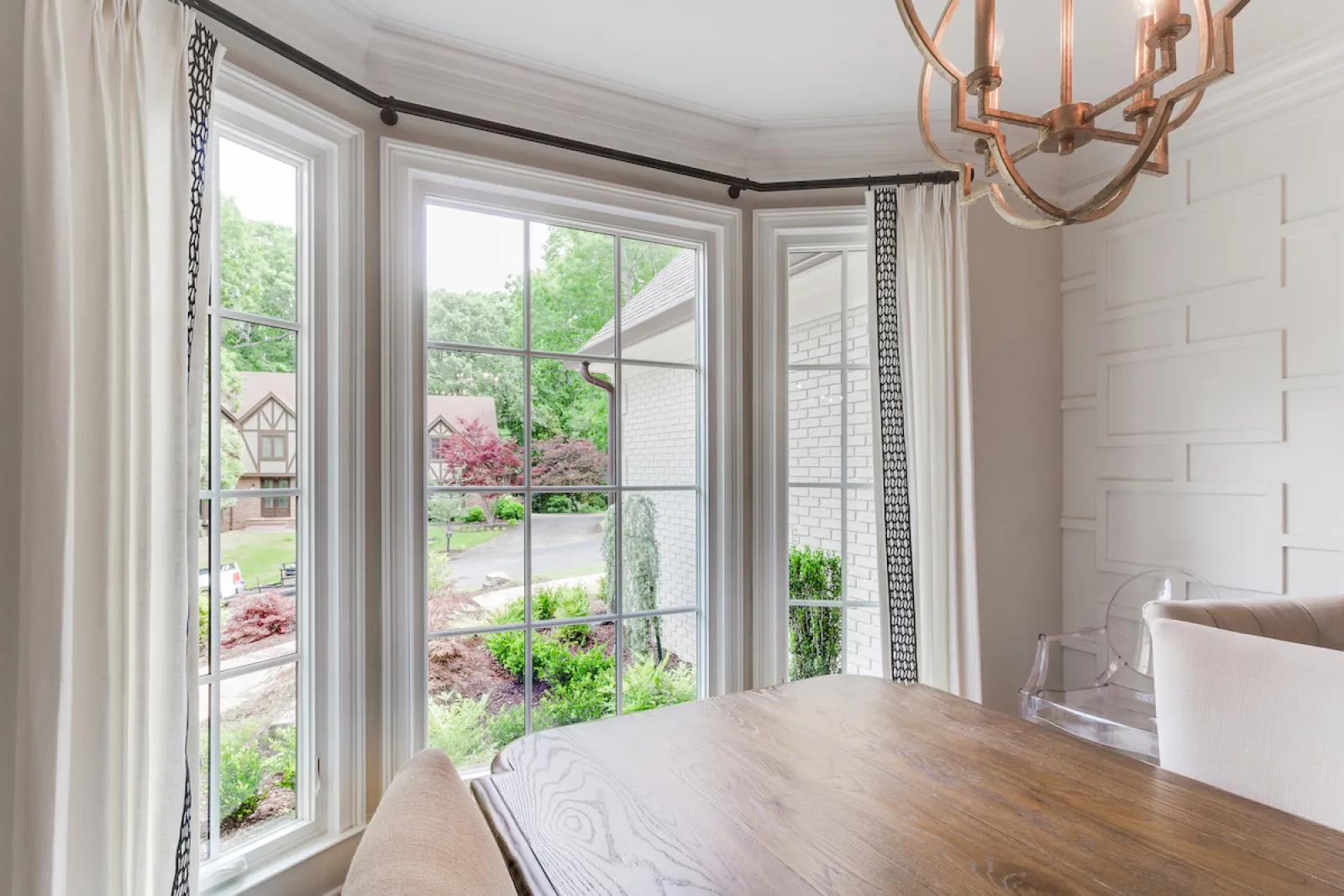 a room with a table and a window with a view of the street