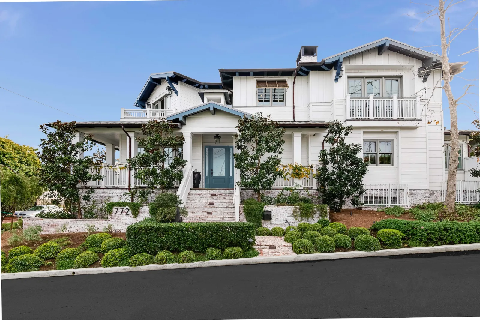 A large white home with a blue front door