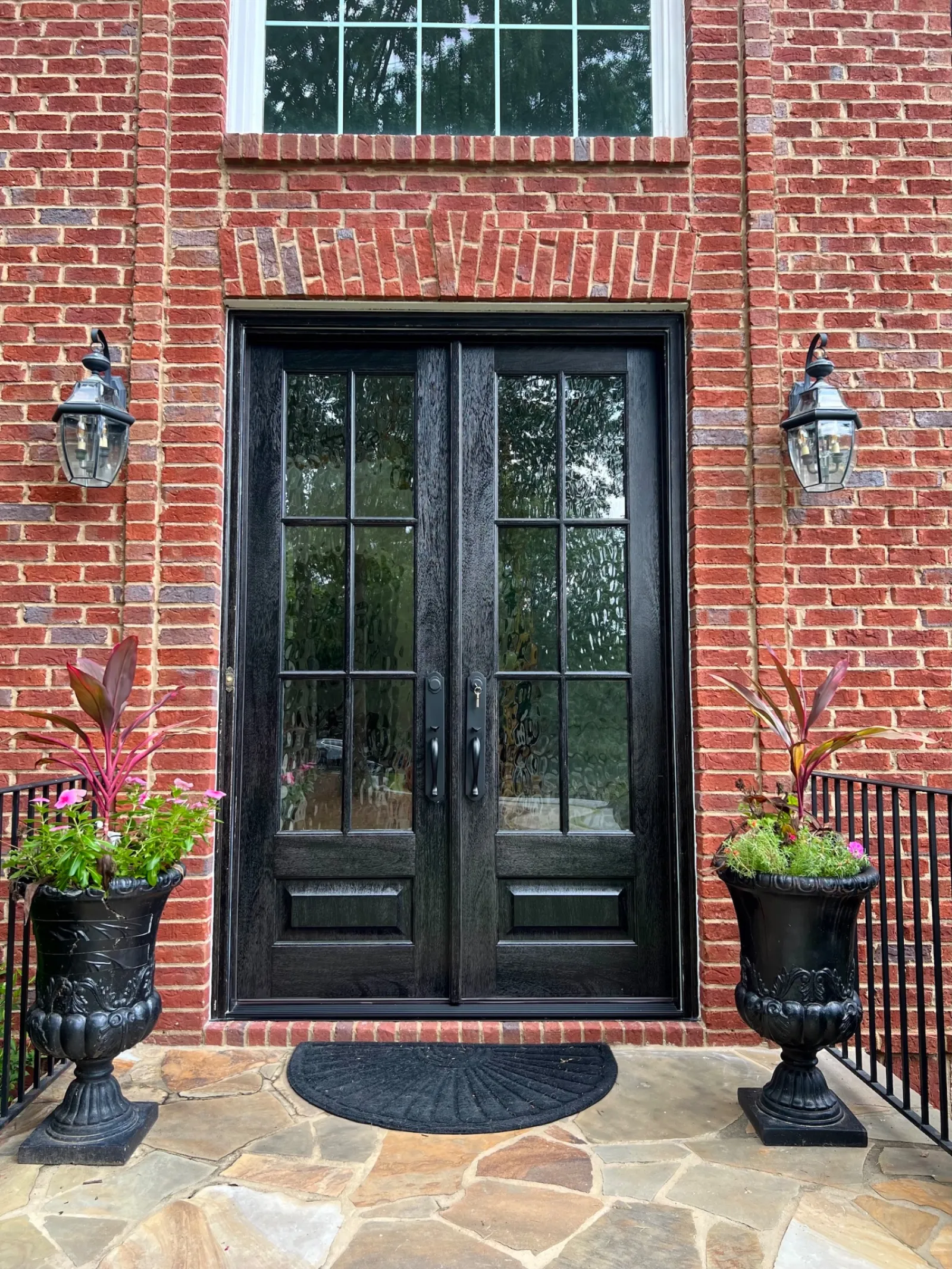brick house with black French style entry doors