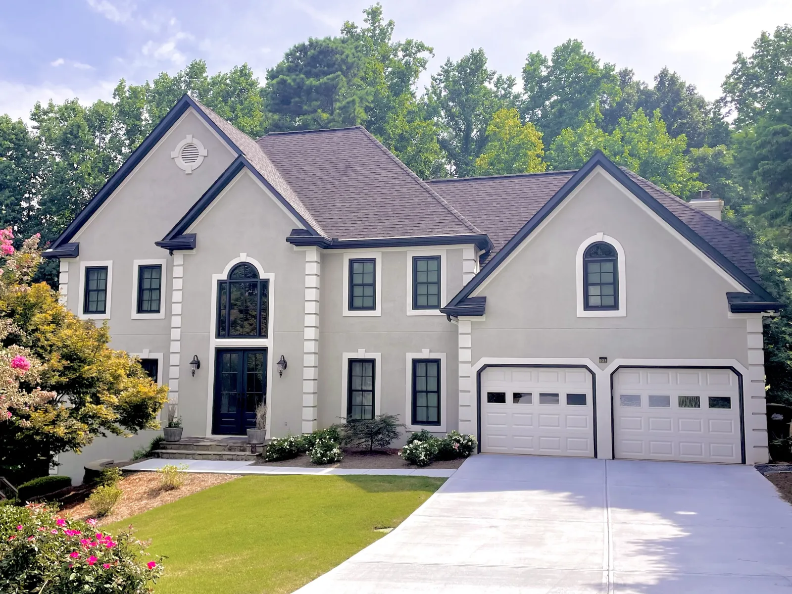 Gray house with white and black trim and black MaxCraft double entry door