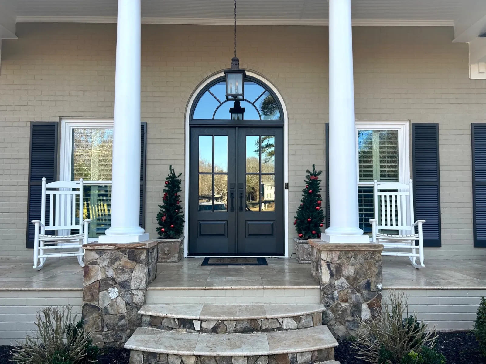 Black double front doors with transom elevates the exterior of the house