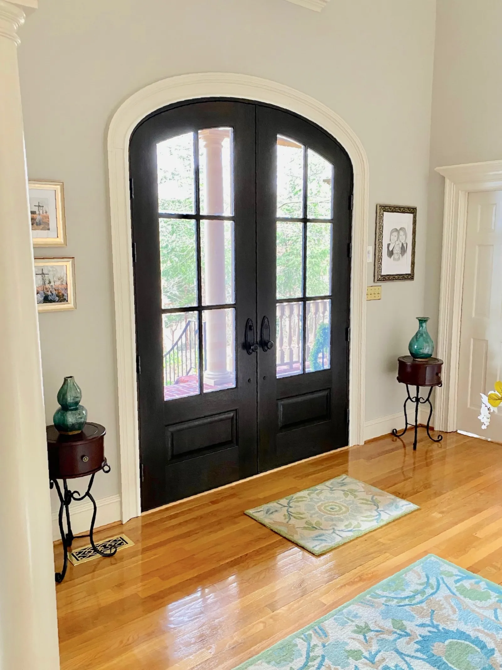 Entryway with hardwood floors and arched double entry doors