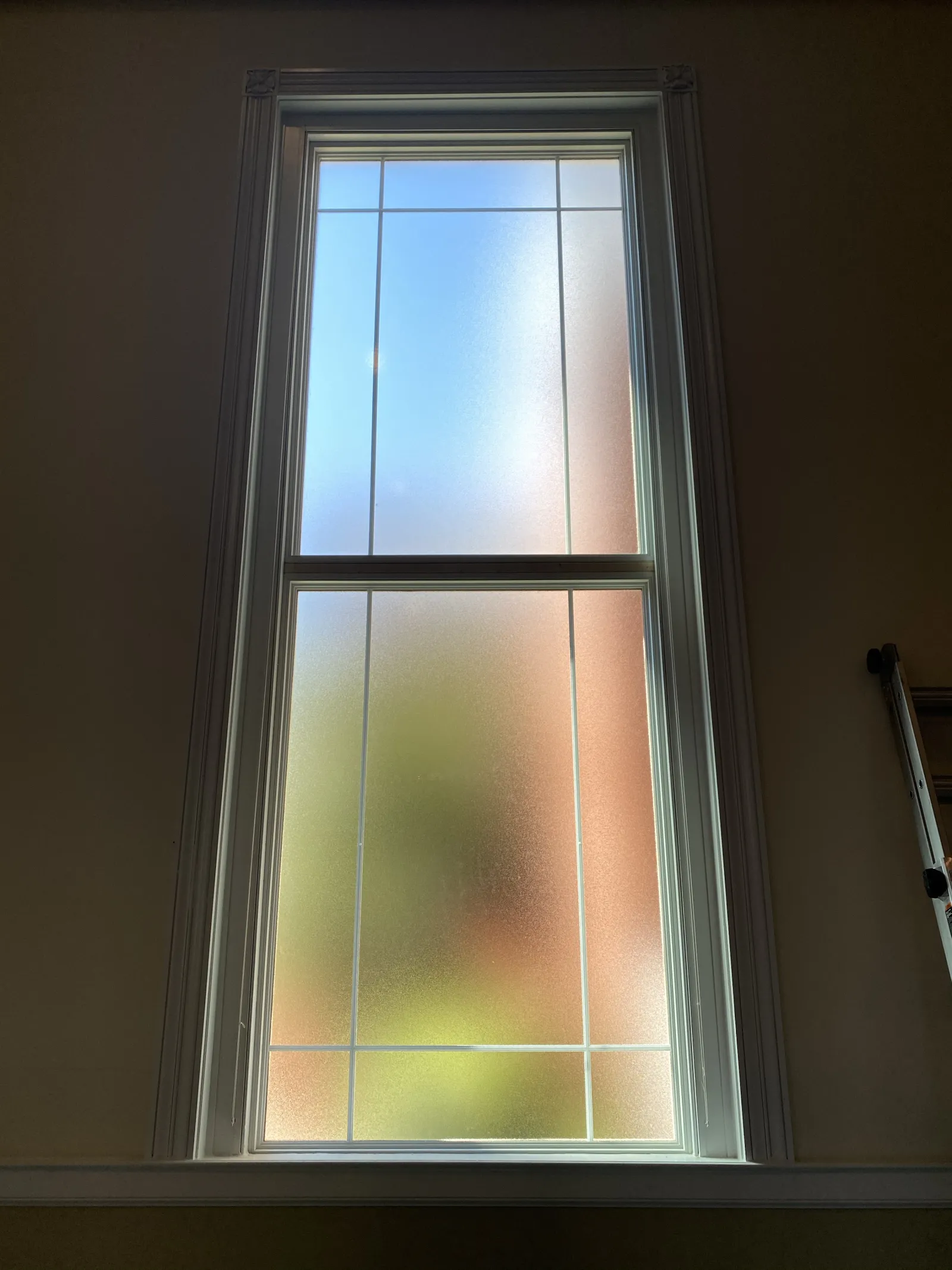 a window with a light shining through