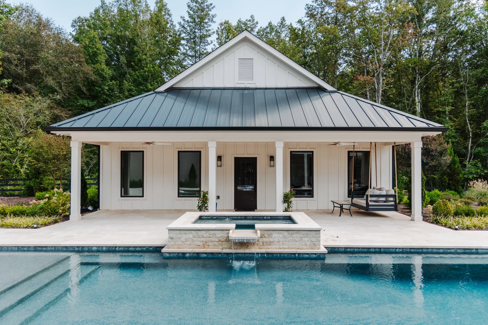 Modern farmhouse style pool house with black fiberglass Infinity Windows