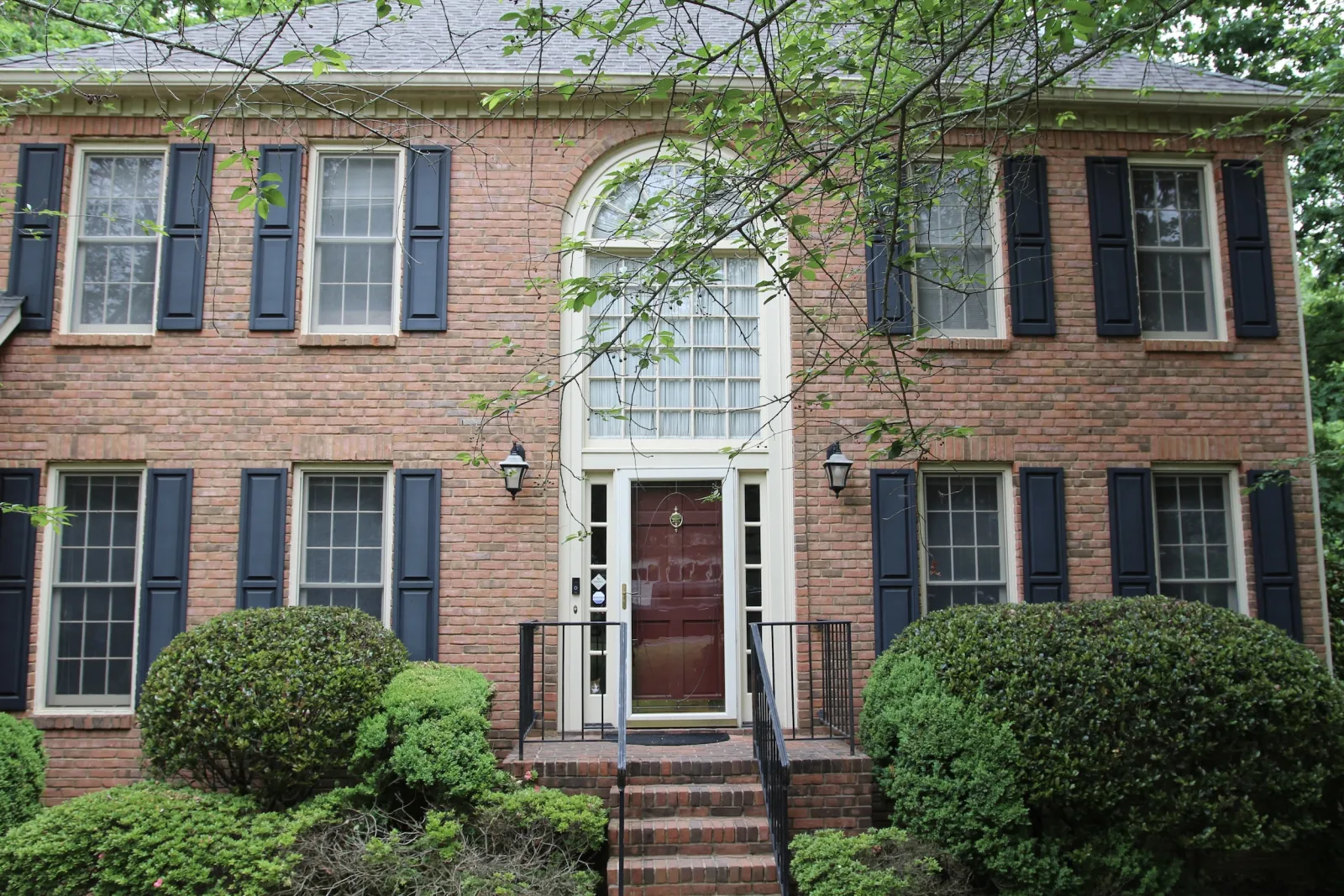 brick home with older windows and door