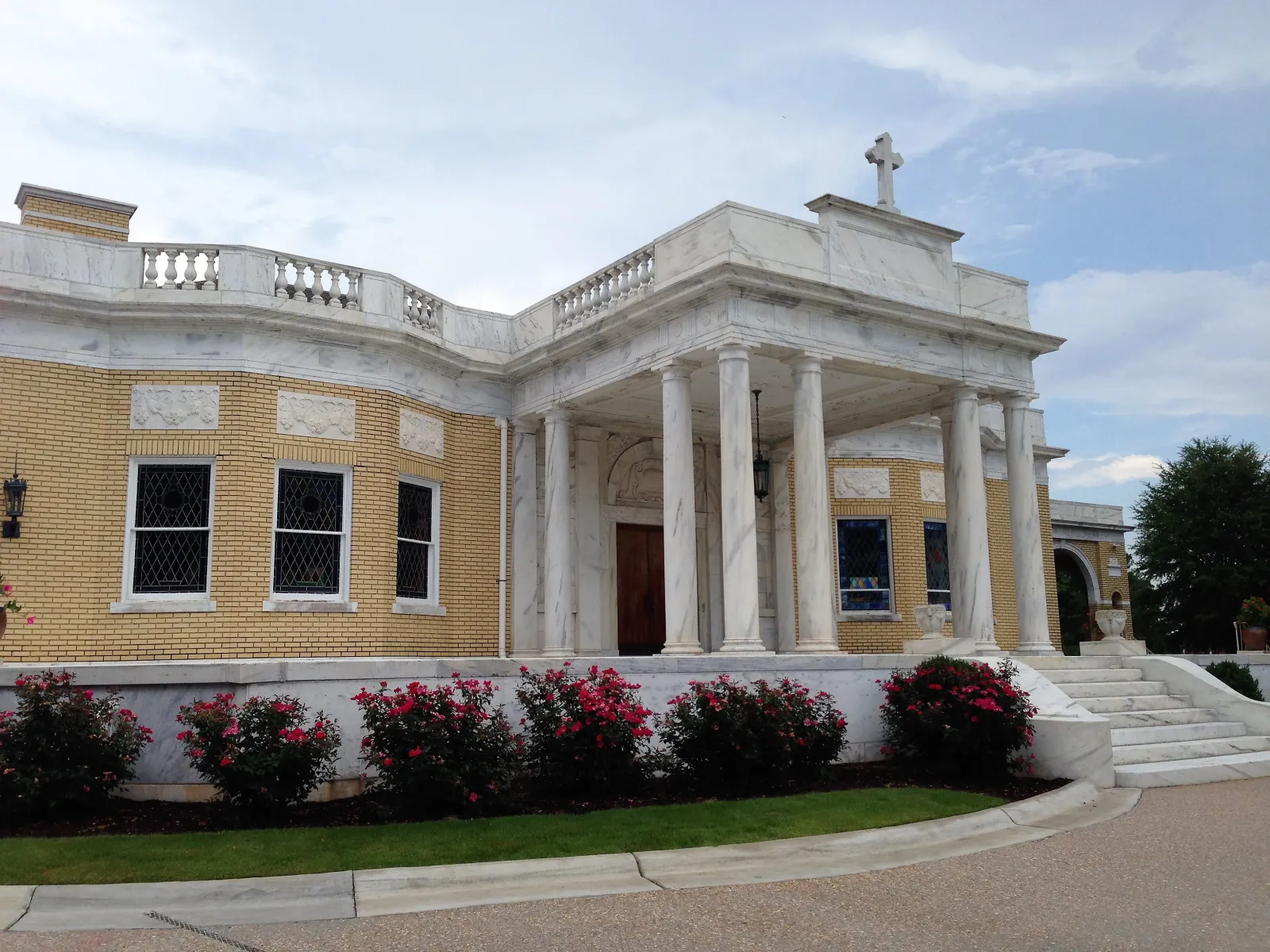 a building with pillars and a statue on top