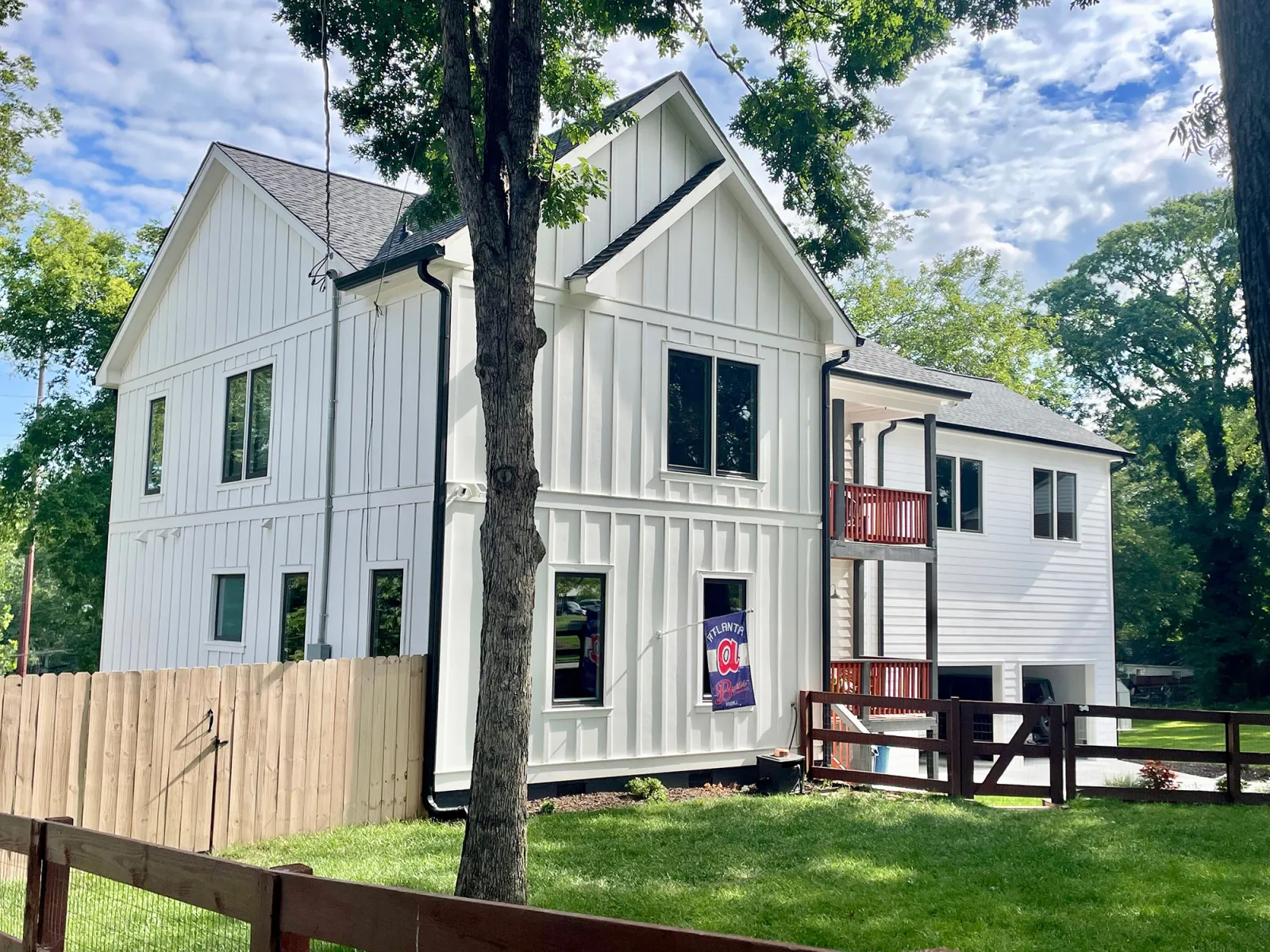 a white house with a tree in front of it