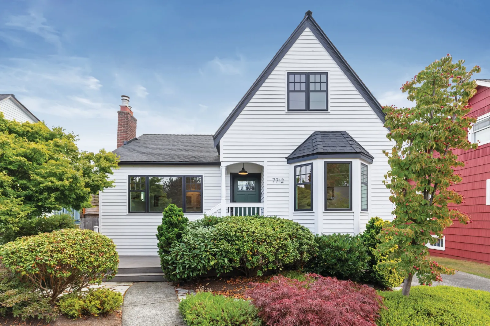 Contemporary black casement windows on a white cottage-style home, a popular architectural trend in Nashville and Davidson County.