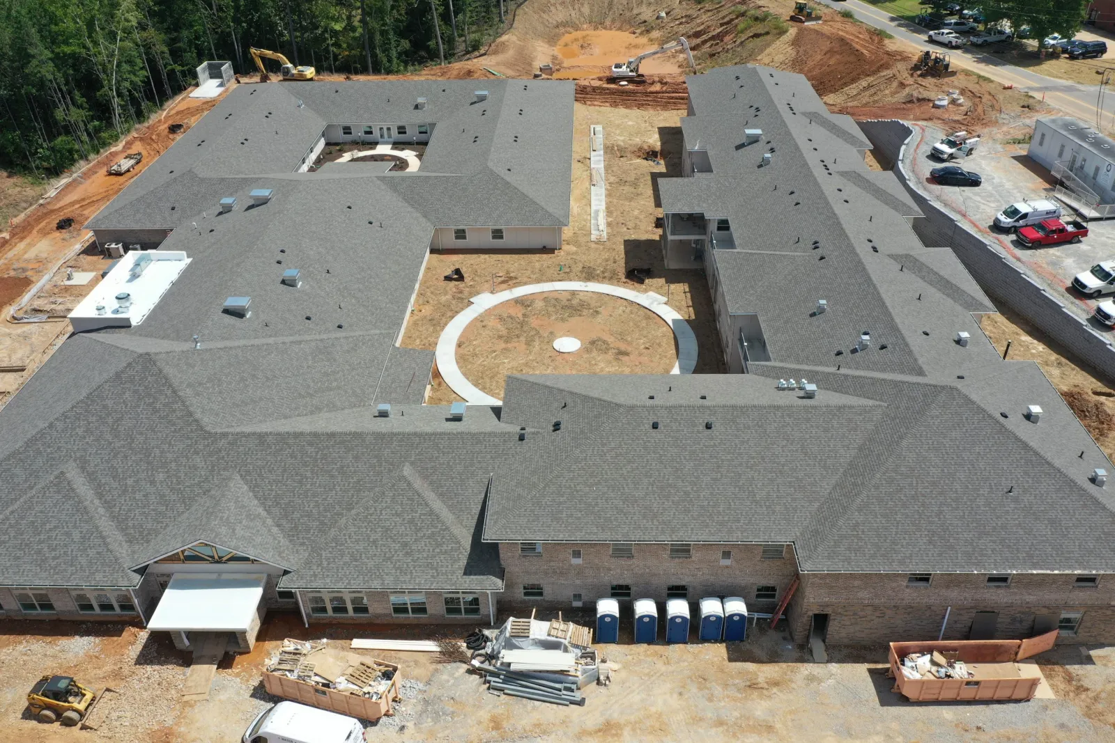 a large building with a road and cars in the front