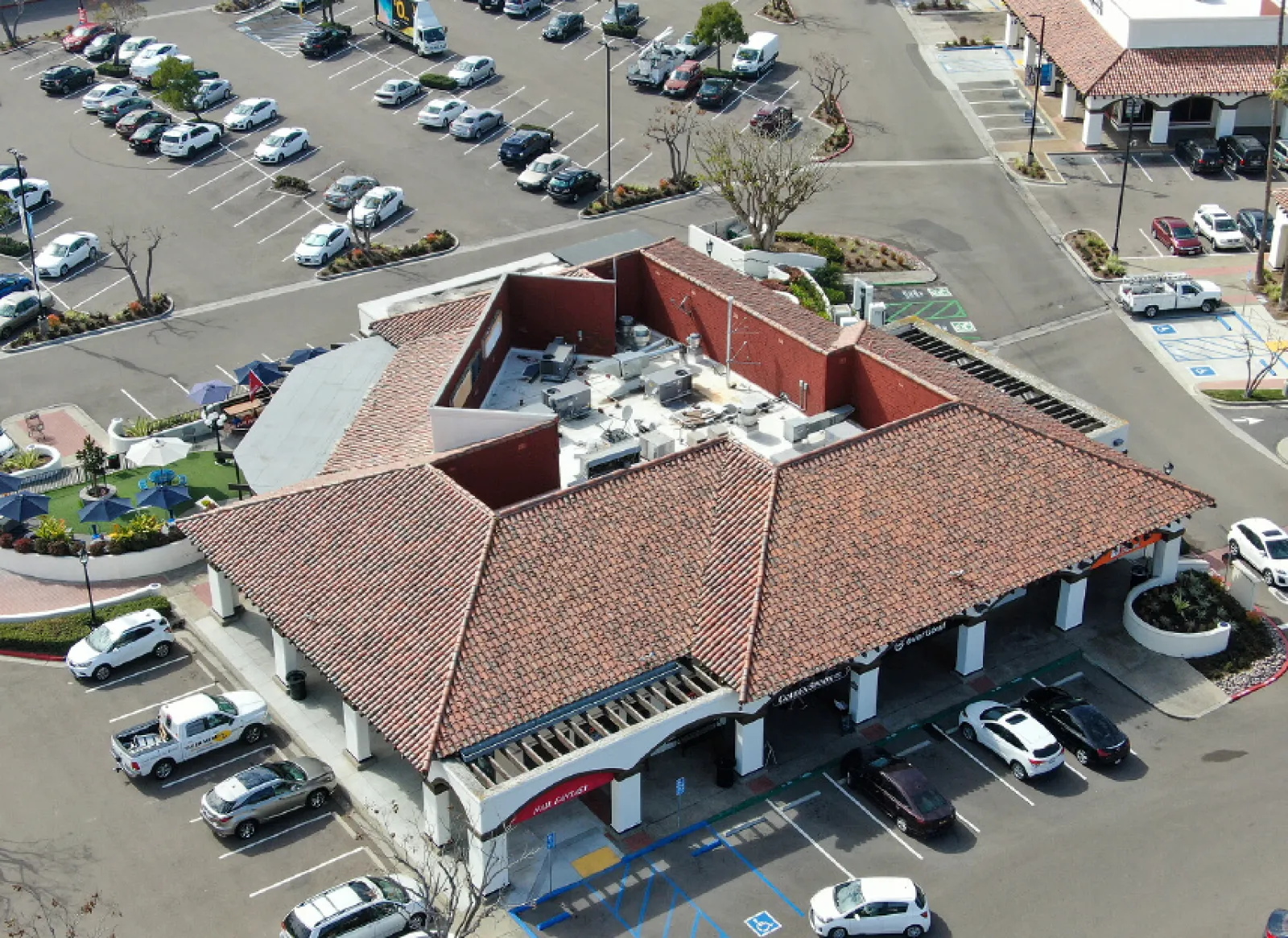 a building with a parking lot and cars in the background