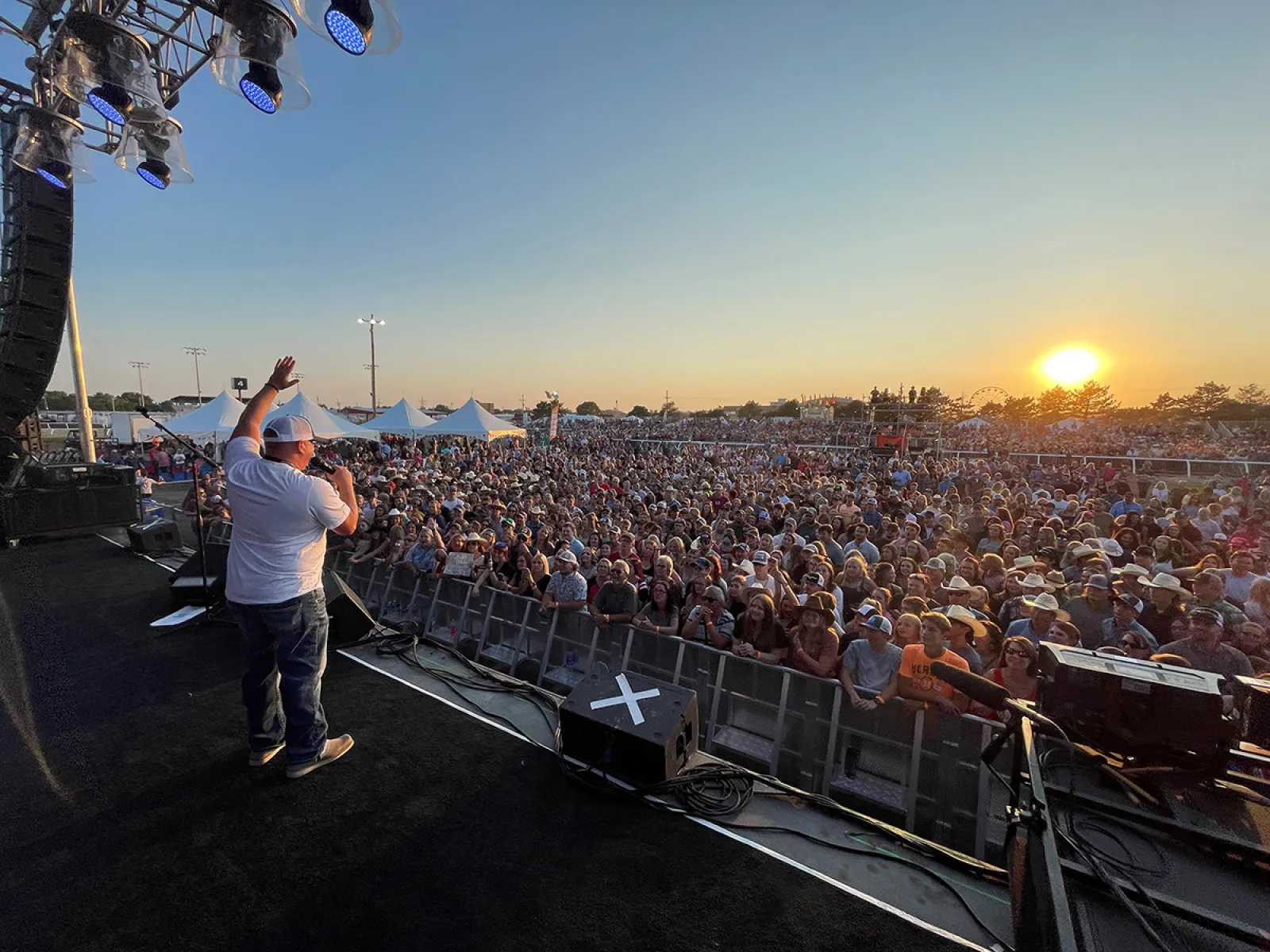 a person on a stage with a crowd watching