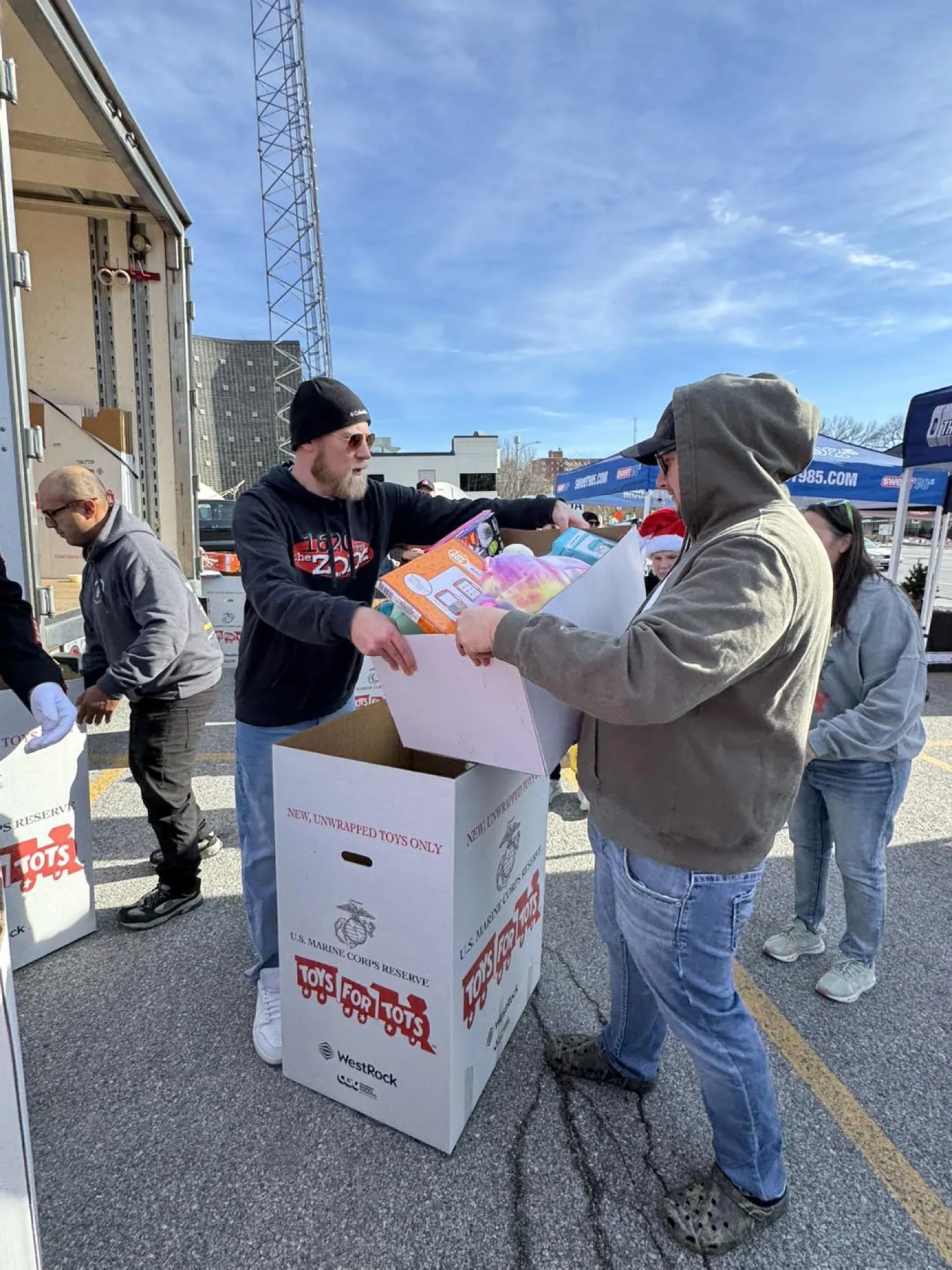 a person handing a box to another man